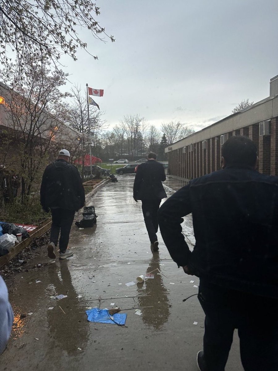 InformedUser3's tweet photo. @MooreintheAM Reposting from another user 
“This photo is incredible. 

A rain-soaked defeated Liberal MP walking along trash filled streets with the pride flag flying in the distance as he grapples with the consequences of his own party’s decisions.” https://t.co/YpEHPy3JeE