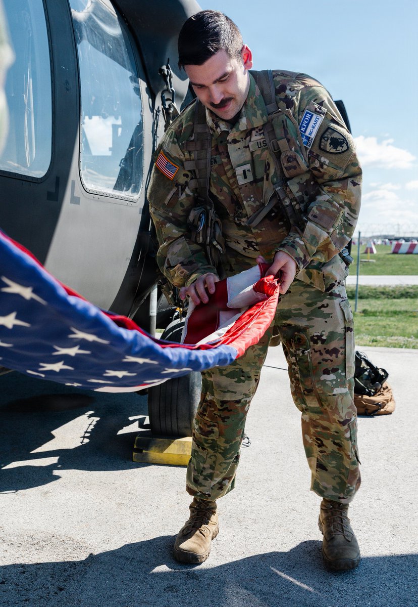 CONG1860's tweet photo. CONG's own 1LT Jansen, assigned to NATO Kosovo Force, is carrying on family tradition, flying with an American flag given by his father. This flag has been carried by members of his family during their deployments it serves as a symbol of shared commitment to military service. https://t.co/OUw1tOMGEB