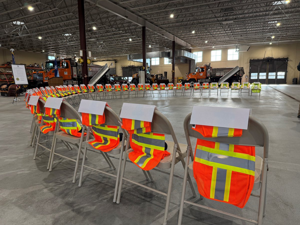 mndotscentral's tweet photo. A ceremony was held at MnDOT in Mankato today to honor transportation workers who have been injured or killed while working on MN highways. The display of empty chairs, each draped with a safety vest and hat, represents the highway workers who lost their lives while on the job. https://t.co/IG5FbBcc5C