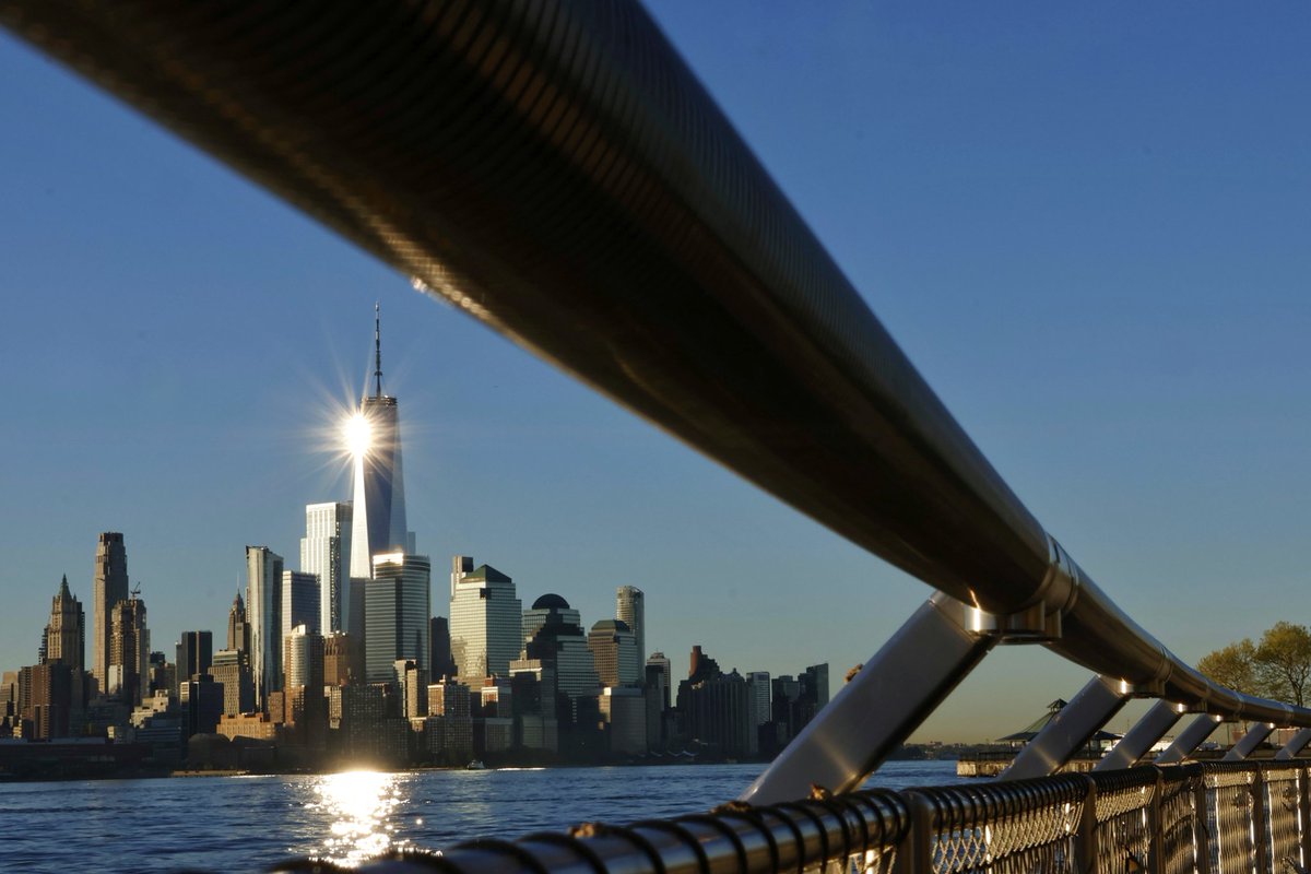 GaryHershorn's tweet image. The sun reflects off of One World Trade Center as it rises in New York City, Tuesday morning #newyorkcity #nyc #newyork #sunrise