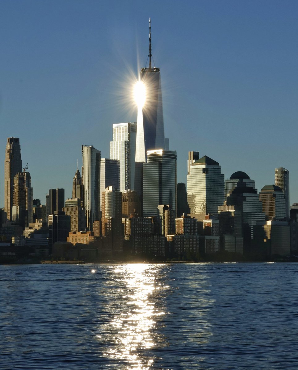 GaryHershorn's tweet image. The sun reflects off of One World Trade Center as it rises in New York City, Tuesday morning #newyorkcity #nyc #newyork #sunrise