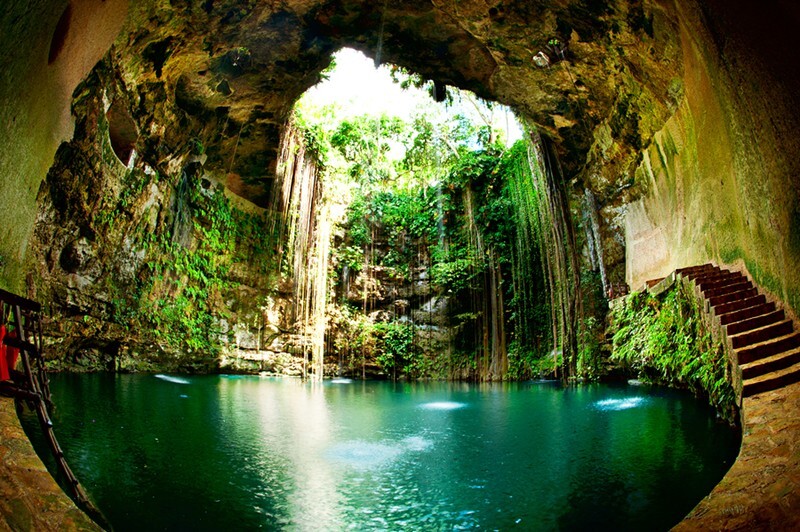 AnytimeTravel_'s tweet photo. This is Ik Kil Cenote, and yes — it looks exactly like this in person.

Tucked just outside Chichén Itzá in the Yucatán, it's a natural sinkhole fed by underground rivers. The vines hang from the opening above, the water is that shade of green, and you can actually swim in... https://t.co/BjAojTRoZT