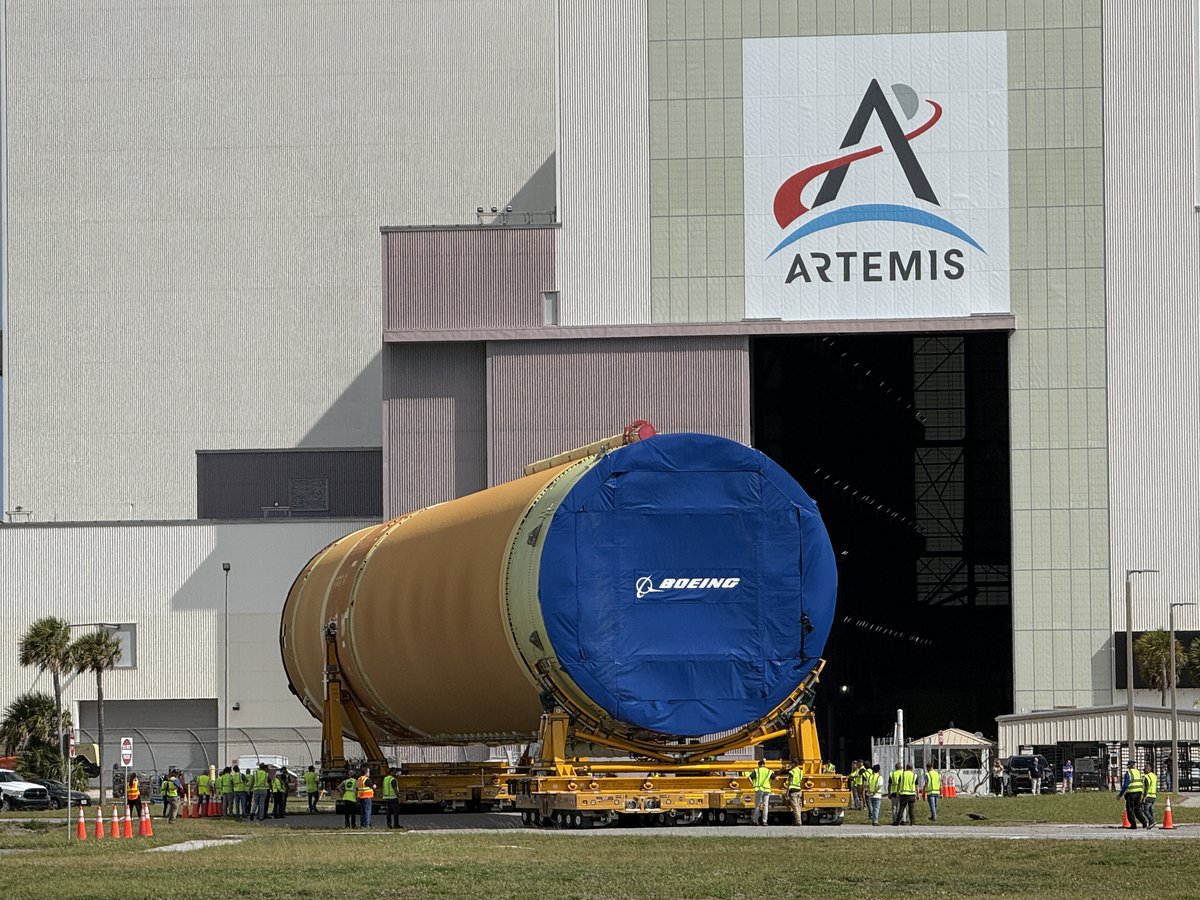 gpallone13's tweet photo. CORE VALUES: @NASAArtemis III core stage rolled into the VAB for processing. Special guest Artemis II Zero G mascot RISE makes a special appearance to welcome the booster. Mission set for mid-late 2027. Pics = GP @MyNews13 https://t.co/3wcAqi7UfG