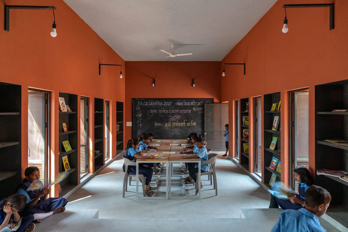 shavnyuyngah's tweet photo. A school is not a box children sit in. It is a space that teaches them before the lesson begins.

Belgaon Dhaga School. Nashik, Maharashtra, India. Architect: Pooja Khairnar, pk_iNCEPTiON. 1,050 m². Completed 2025.

The existing school was a rigid linear block, one long row of classrooms facing an open ground. The intervention refused to repeat that logic. Instead a series of smaller blocks arranged like a village, connected by courtyards, shaded corridors and brick terraces that blur the boundary between classroom and playground.
Buildings oriented to the sun path for maximum shade. Perforated openings and louvered panels for natural ventilation. Local brick throughout. No air conditioning in a school that needs none.

The circular courtyard at the centre is not a design gesture, it is an amphitheatre, a gathering space, a flag ceremony ground, a place where the community sits in the evening.

This is what it looks like when an architect asks what children need from a building rather than what a building requires of children.