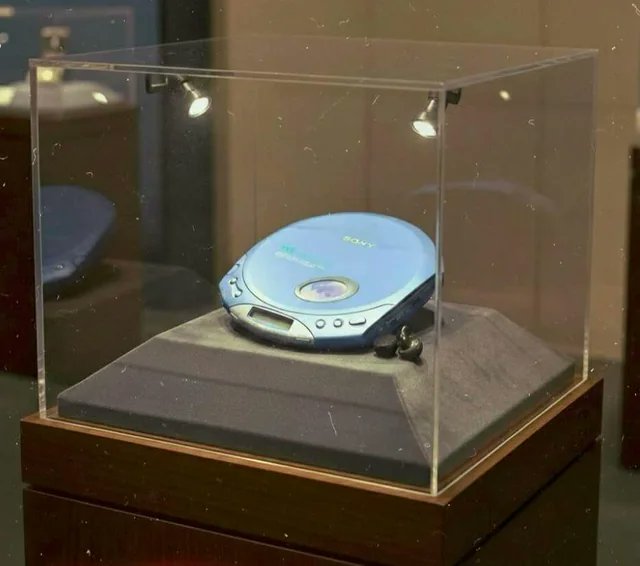 A Sony Discman from 2001, now displayed like an ancient artifact. Once used by teenagers to listen to Linkin Park, carefully walk without making the CD skip, and pretend life was harder than it really was.