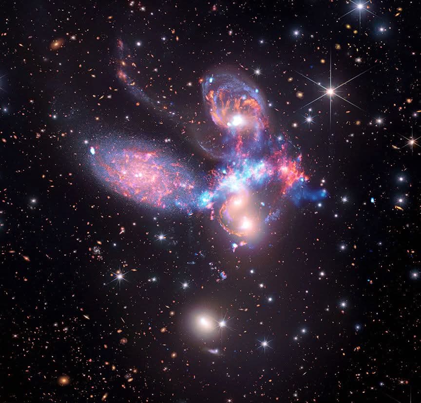 konstructivizm's tweet photo. A Cosmic Dance: 
Stephan’s Quintet in X-RayDeep in the constellation Pegasus, 290 million light-years from Earth, five galaxies are locked in a breathtaking gravitational ballet known as Stephan’s Quintet. Four of them are caught in a chaotic cosmic collision, their distorted shapes and glowing tidal tails telling the story of a violent, ongoing merger that has been unfolding for hundreds of millions of years.The drama reaches its peak as one galaxy — NGC 7318B — screams through the group at nearly 2 million miles per hour (over 3,200 km/s). This intruder is plowing through intergalactic gas like a cosmic bullet, generating one of the most massive shock waves ever observed. Heated to tens of millions of degrees, this wave glows brightly in X-rays, shown in striking light blue in the composite https://t.co/dQ4K2mvJRO blending James Webb Space Telescope’s exquisite infrared detail with Chandra X-ray Observatory’s high-energy vision (and legacy data from the retired Spitzer Space Telescope), astronomers have created a multi-wavelength masterpiece. You can see:Sweeping, golden tidal tails of stripped gas and dust
Intense bursts of new star formation triggered by the gravitational turmoil
The hidden violence of the shock front ripping through the group

This image is more than just beautiful — it’s a powerful demonstration of how different wavelengths of light reveal layers of the universe we would otherwise miss. Infrared unveils the cool dust and young stars; X-rays expose the scorching, high-energy violence of the collision.Stephan’s Quintet reminds us that galaxies don’t live in isolation. They collide, merge, reshape each other, and spark new generations of stars in a never-ending cosmic dance.
Credit: NASA, ESA, CSA, STScI, CXC
Image Data: James Webb Space Telescope (infrared), Chandra X-ray Observatory (X-ray), Spitzer Space Telescope