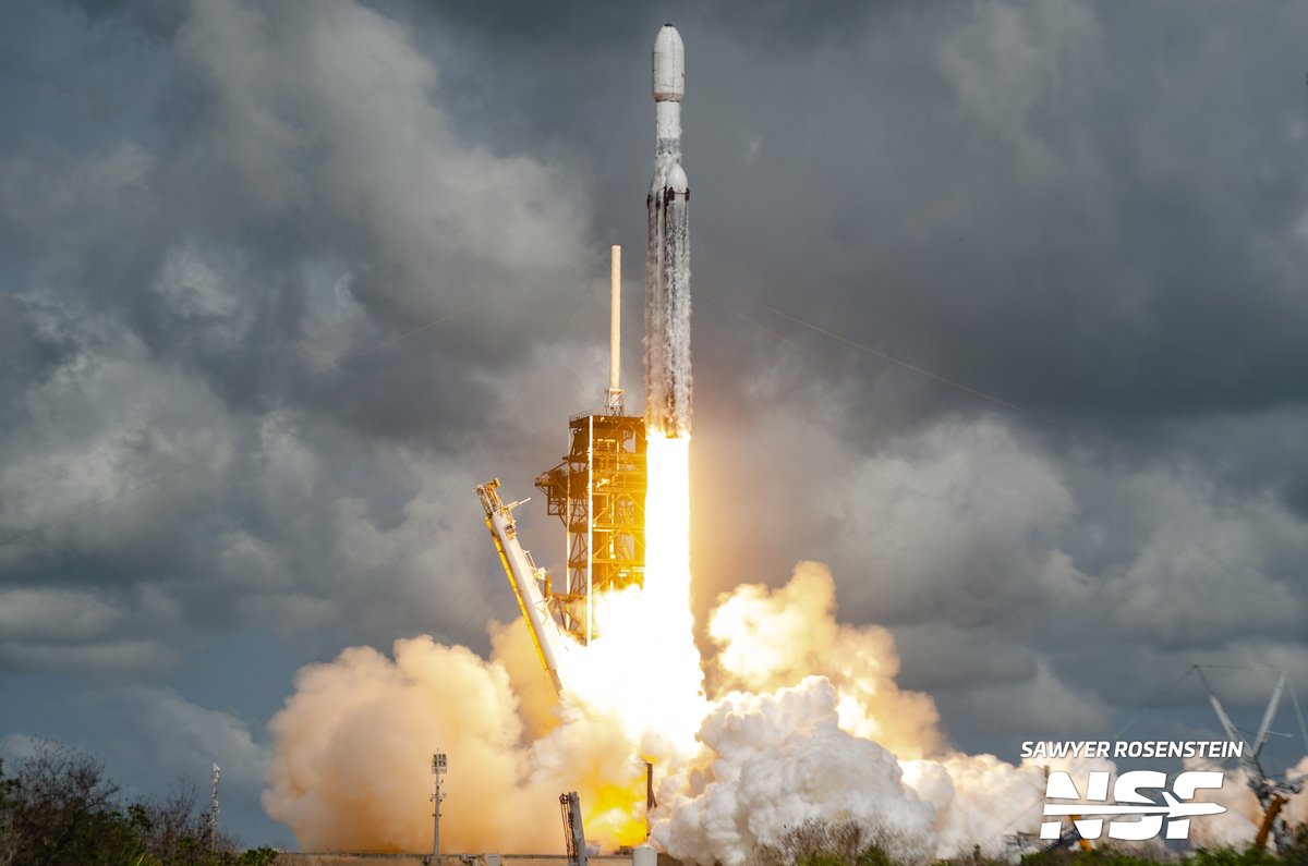 thenasaman's tweet photo. Falcon Heavy is back with a vengeance. After 18 months of no launches, FH lifts off on the ViaSat-3 F3 mission, returning launches to LC-39A after a hiatus from Falcon missions there.

This was a remote camera set near the launch pad. Learn about the mission in my @NASASpaceflight article https://t.co/gAX60xqlLm
