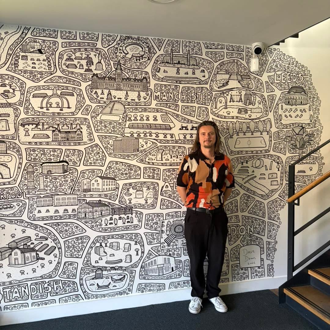 DaveDraws_'s tweet photo. A snap of me with the mural I created at @PlanitIE’s Altrincham offices last week!
This mural was super fun to create as I drew projects that the company had worked on in Manchester, Altrincham, Liverpool, Leeds and London! https://t.co/ZaTvP6jxEI