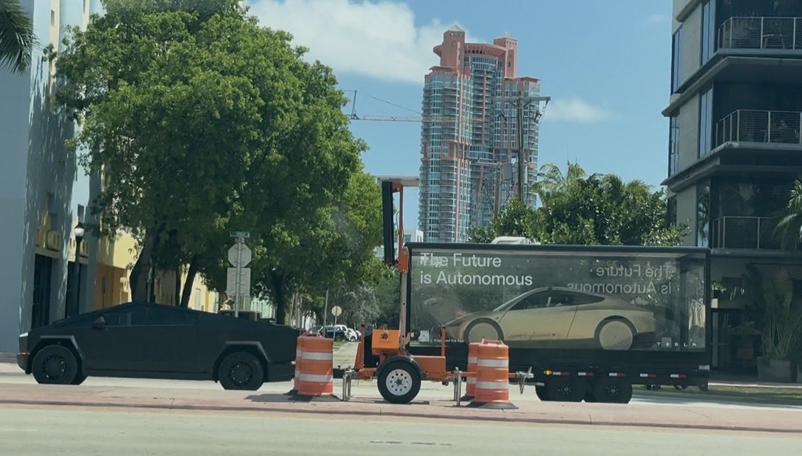 rustyblevster's tweet photo. Cybercab trailer display rolling around in Miami Beach behind a Cybertruck. https://t.co/EhrlzL7jxu