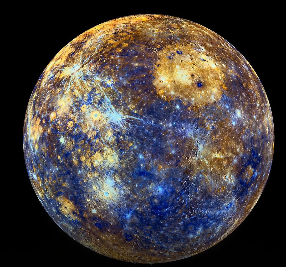 konstructivizm's tweet photo. Mercury just got the glow-up it deserved.Forget everything you thought you knew about the Sun’s closest planet. This isn’t the dull, monotonous grey rock from old textbooks. What you’re seeing is Mercury in living color — a breathtaking swirling masterpiece of electric blues, molten golds, rich coppers, and deep shadows, revealed by NASA’s MESSENGER spacecraft.

These aren’t artistic filters. They’re real scientific data. MESSENGER’s Wide Angle Camera shot through 11 different filters across wavelengths invisible to human eyes. When scientists combined them, Mercury’s hidden chemistry exploded into view.Those vivid electric blue streaks? Fresh material excavated by relatively recent impacts, sparkling against the ancient surface.  
The warm golden-tan plains? Vast volcanic lava flows from billions of years ago.  
The darker patches? Low-reflectance rocks that have been scorched and altered by sunlight 11 times more intense than we experience on Earth.

This tiny world is a speed demon — racing around the Sun at 46.6 km per second (29 mph), completing a “year” in just 88 Earth days. Surface temperatures swing wildly from a blistering 450°C (840°F) in the day to frigid nights.Yet MESSENGER pulled off the impossible. Protected by a ceramic heat shield, it became the first spacecraft to orbit Mercury in 2011. For four years it mapped every inch of the planet before deliberately crashing into the surface in 2015 — sending back spectacular postcards like this right until the end.A scorched, cratered world full of surprises, now painted in colors no human eye was ever meant to see.
Source: NASA / Johns Hopkins University Applied Physics Laboratory / Carnegie Institution of Washington (MESSENGER mission)