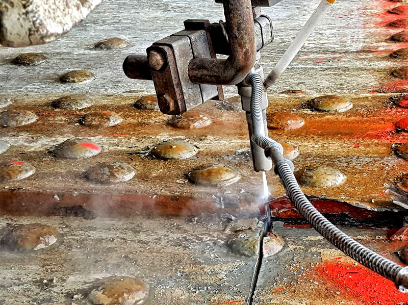 rglservices's tweet photo. Precision Abrasive Water Jet Cutting During Gasholder Decommissioning

During the safe decommissioning of a gasholder, our team deployed advanced abrasive water jet technology to create precise vent holes through the structure.

The image shows the water jet in action, cleanly cutting through double-layered steel plating and a solid rivet head. While abrasive water jet cutting can produce some sparks, they are effectively suppressed by the high-volume water stream, resulting in a truly cold-cutting process with minimal heat generation. This makes it one of the safest and most reliable methods for steel cutting in hazardous, volatile, or potentially explosive environments where traditional hot-cutting techniques cannot be used.

At RGL, safety remains our top priority. Our abrasive water jet services are trusted across the energy, petrochemical, and industrial decommissioning sectors for delivering precision and control in high-risk conditions.

Learn more about our Abrasive Water Jet Cutting Services:
 https://t.co/Z3xE3U0xoB

#RGLservices #WaterJetting