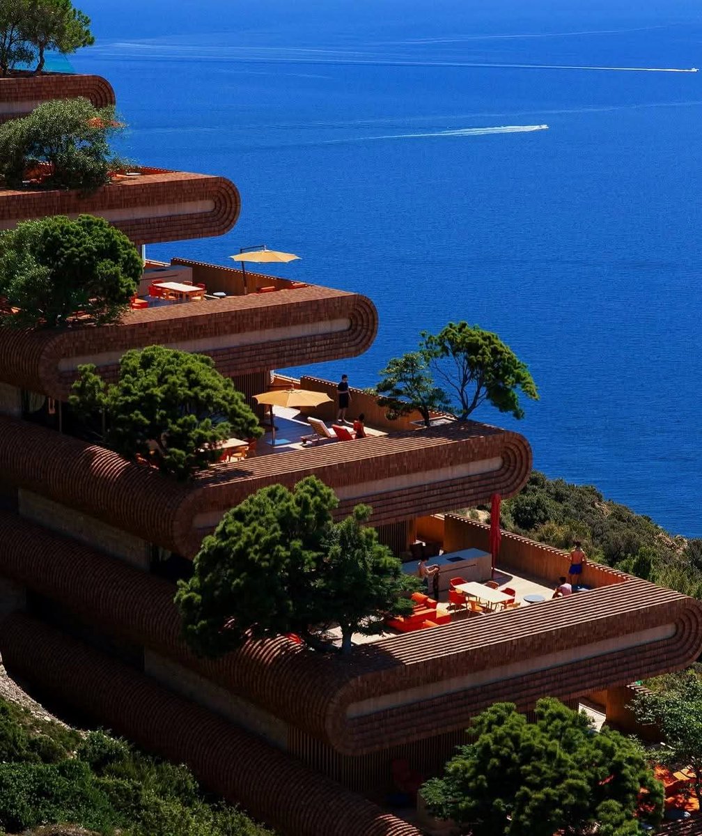 CapturedLtd's tweet photo. The Northern Apartments by Studio Precht and 10 Architects are a breathtaking example of topography-driven design. Located on the rugged coast of Albania, the building features terraced, curved slabs that mimic the natural flow of the hillside.  Stepping with the slope. https://t.co/aHlRd0PKXC