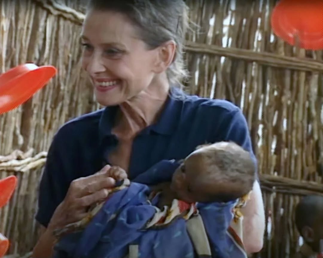 UNICEF Goodwill Ambassador Audrey Hepburn photographed holding a severely malnourished child at a UNICEF-assisted feeding centre in Baidoa, Somalia, 1992