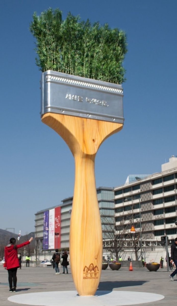 WeirdWhere's tweet image. This is a public art installation at Gwanghwamun Square in Seoul, South Korea.  

Created for a Korea Forest Service campaign, the "bristles" are actually living pine trees.

• The Message: The Korean text translates to "Turning the world green."

#art #sculpture #paint #funny