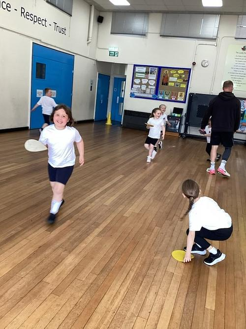 St_Nicholas_CEP's tweet photo. What an energetic PE session with Kav, Badgers! 🏃

We turned the hall into a movement playground—calling out body parts to place on circles (shoulders, elbows, knees, even ears!).

Then came the pizza game 🍕—carefully protecting their “pizza” circles while moving. 
#NewRomney https://t.co/lgNRYE0iee