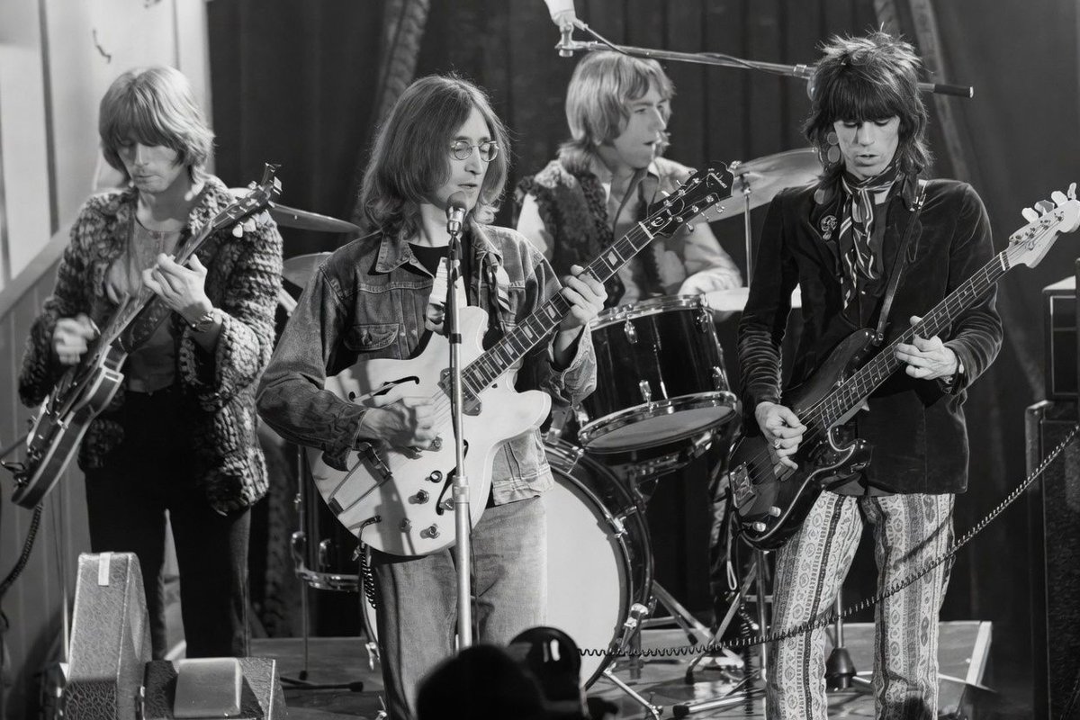 John Lennon put together the ultimate temporary band for The Rolling Stones Rock and Roll Circus in 1968. He called them The Dirty Mac. The lineup featured Eric Clapton on lead guitar, Lennon on rhythm, Mitch Mitchell on drums, and Keith Richards playing bass. Ethan Russell