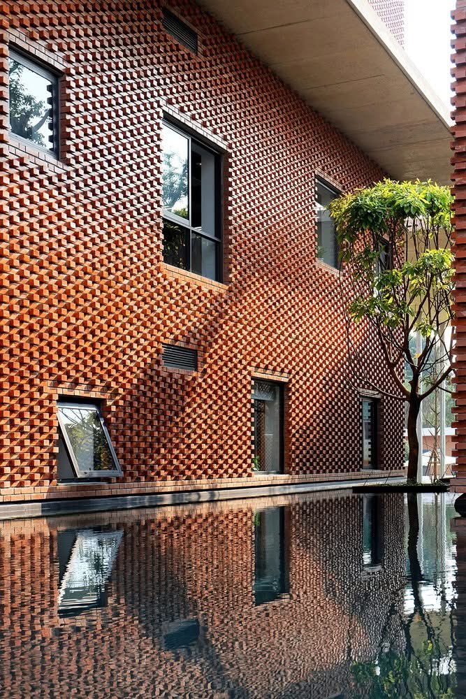 shavnyuyngah's tweet photo. Vietnam figured out what brick can do when you stop treating it like a default.

The Viettel Academy Educational Center sits inside a hi-tech park 30km from Hanoi but the architecture refuses to perform that. Brick courtyards. Water channels. Trees growing from rooftops. The building pulls you inward, not outward.

VTN Architects used the brick envelope as a climate tool. The textured facade isn’t decorative, it’s working. Each protruding brick creates micro-shadow, breaking direct sun before it hits the wall plane. The water features aren’t aesthetic either. They cool the air that circulates through the open corridors.

This is what passive design looks like when it’s taken seriously: no mechanical compensation for a bad envelope. The building does the work.

Brick isn’t a vernacular gesture. It’s a climate solution we need to adapt. 

Viettel Academy Educational Center, Hanoi, Vietnam. VTN Architects. 📷 Hiroyuki Oki