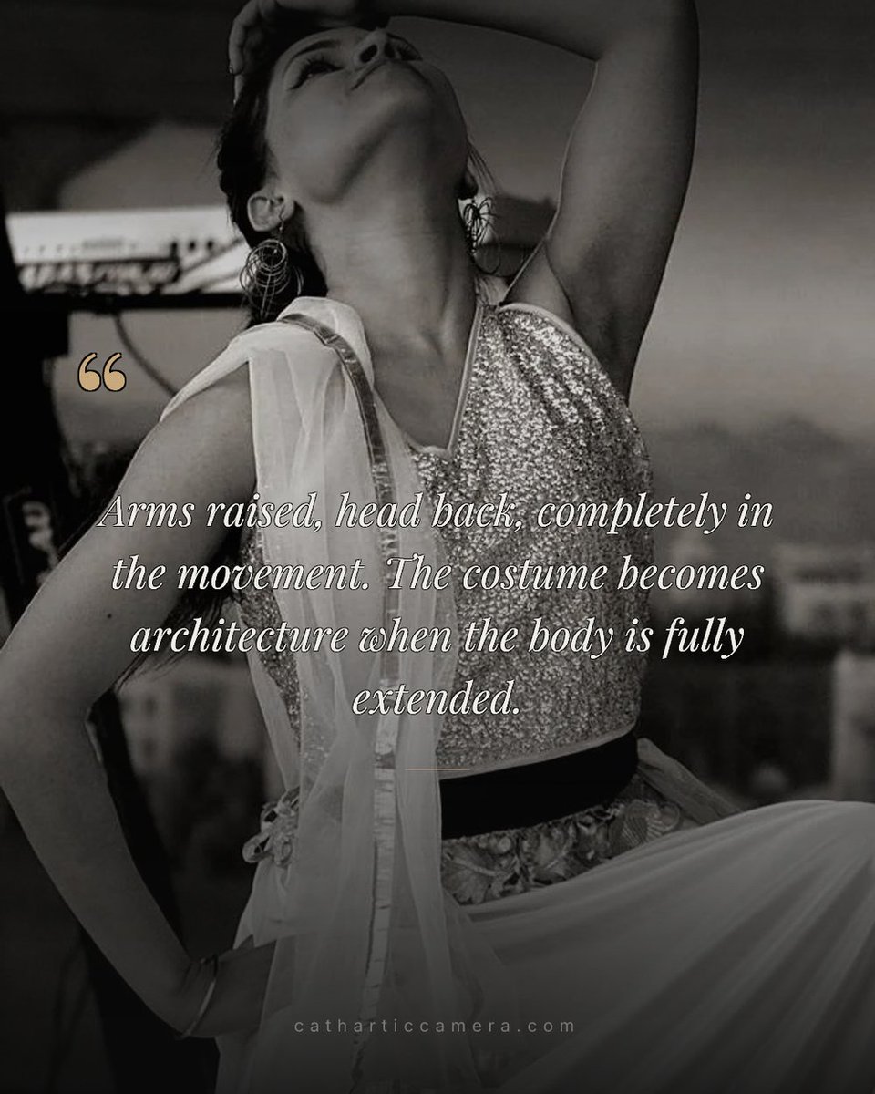 Catharticcamera's tweet photo. Arms raised, head back, one second of full extension in a twenty-minute sequence. Black and white because the costume becomes architecture without the colour competing for attention. https://t.co/4iETwLNxxy