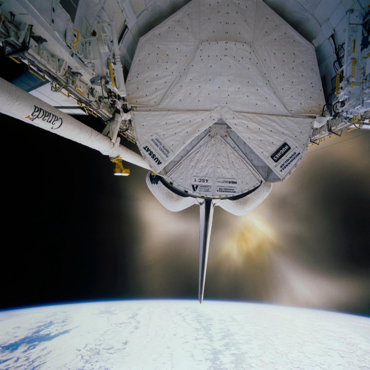 Boneyardsafari's tweet image. Here is a single engine orbital maneuvering system (OMS) firing on the Orbiter Discovery OV-103 in 1985. The payload bay is open and the protective canisters for the AUSSAT communications satellite and the ASC-1 are visible. #spaceshuttle #nasa #boneyardsafari #aviationsafari