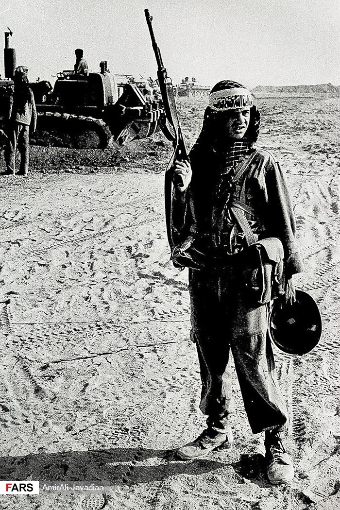joeblillib4090's tweet image. Child Soldier of the Basij next to a bulldozer of the Jihad of Construction during Operation Beit Ol-Moqaddas, 1982.