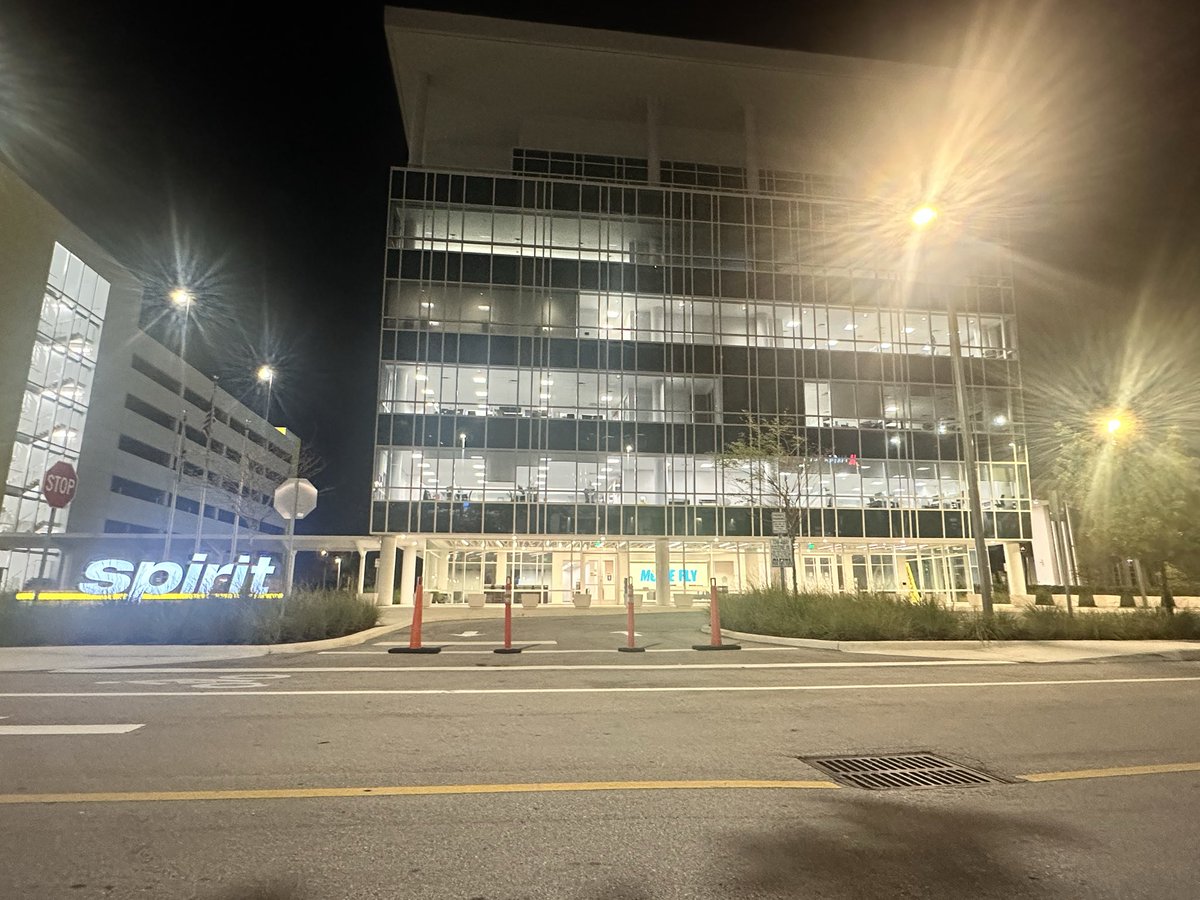 jamiewatson77's tweet photo. Staying at a hotel across the street from #SpiritAirlines headquarters &amp; I just watched 4 gentleman take a selfie together in front of the illuminated sign and hug each other saying their goodbyes. It’s hard not to think of the human element behind the supposed impending shutdown https://t.co/tolqgIQ4T7