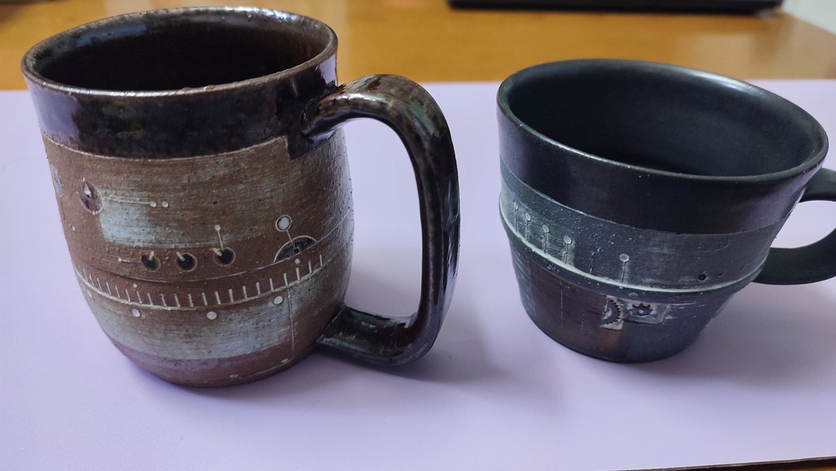 moriqq99's tweet photo. 一昨年くらいにグレーのカップを今年はブラウンのカップ！笠間でミキエダマメさん作のを買ったのだ、何故かデザインに惹かれて😌左はビアカップなのだが酒は呑めないからコーヒー用に使う👍また新作出ないかな〜😚 https://t.co/uEVAnKnnrm