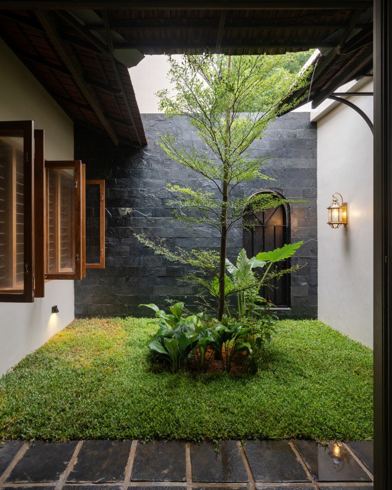shavnyuyngah's tweet photo. When I say Kerala has some of the best documented homes, I know exactly what I’m talking about.

Eden Moss sits on the outskirts of Thrissur, close to a wetland the clients love. The architects didn’t fight that context, they built from it. Sloping terracotta roof. Rough stone base. Brick and clay tile pulled directly from Kerala’s material tradition.

The central courtyard is the organizing idea. Dining, prayer space, and kitchen all open onto it. Light comes in from above. Air moves through. No mechanical compensation needed, the plan does the work.

What makes Kerala architecture worth studying is this consistency. Local materials aren’t a stylistic choice here, they’re the climate logic. Terracotta roofs shed tropical rain and regulate heat. Stone bases resist ground moisture. The landscape and the building are solving the same problem together.

Simple. Grounded. Deliberately local.

📍Eden Moss, Thrissur, Kerala, India. Architects: Urbane Ivy. 
📷 Raw Production