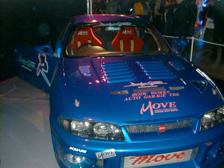 CarSighting's tweet photo. "Ever heard of MOVE TUNING FACTORY in japan?"
That's what some guy innocently asked on a forum in 2009. He had just picked up a 1995 R33 V-Spec, felt like it was an absolute rocket, and couldn't figure out what that weird sticker on his ECU was.

Move Tuning Factory was a Japanese tuner based in Hino, Tokyo, primarily known for the Skyline GT-R. In 1997 they claimed the fastest Skyline in Japan, their brochure was simply titled "Over 200MPH".
Square reached out to them for Racing Lagoon in 1999. Their demo car appears in the game. The Racing Lagoon logo sits on their real cars in return.