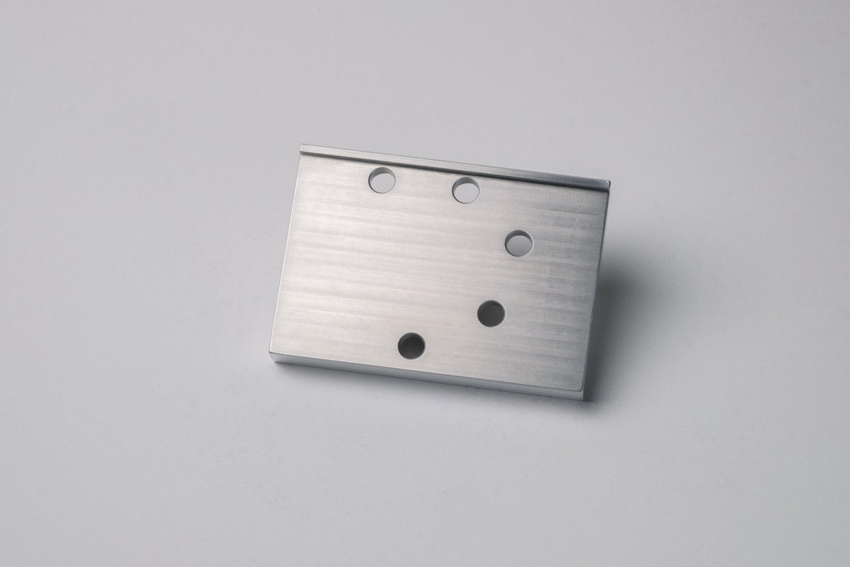 MoonlightLuke's tweet photo. I just finished my latest CNC project:

A motorcycle brake pedal enlarger with a custom bottom plate/nut. Since one of the sides is angled I couldn't just clamp it back into the vise after milling the top and side features, so I also had to make a custom fixture plate as well. https://t.co/JXFhWbDx1S