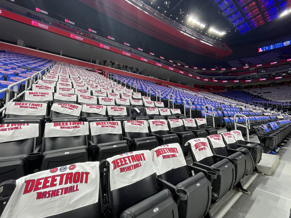 JoshuaBRobbins's tweet photo. Setting the scene for Game 7 this afternoon between the Pistons and Magic in Detroit. The items on the chair backs are "Deeetroit Basketball" towels, alternating from blue to white by section: https://t.co/2CU0PHnvzy