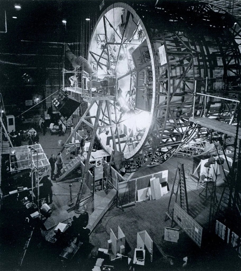 SpaceScienceX's tweet photo. The movie 2001: A Space Odyssey came out in 1968.
It showed a spinning space station that creates fake gravity.
This idea uses spinning to push people outward, like a fast merry-go-round.
Real scientists still study this for long space trips to Mars.

The film's effects looked so real that they amazed people even before we landed on the Moon.