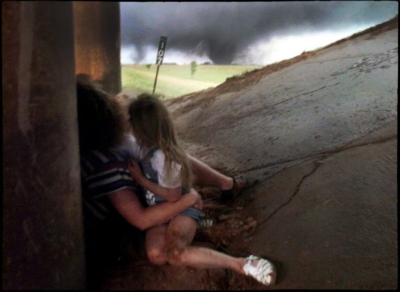Ham_BklynWx's tweet photo. The 1999 Moore tornado created one of the most dangerous myths in weather history: The Highway Overpass. 🛑

This photo of a family under an overpass on the H.E. Bailey Turnpike remains one of the most widely seen images of May 3. However, the captions used by national news magazines at the time created a dangerous public perception.

By implying that those who stayed home "paid the price," the media inadvertently suggested that seeking shelter under a bridge was safer than an interior room. This is false.

The Reality:

• Most people who followed standard safety guidelines (staying in a home/shelter) survived with minor injuries.

• Overpasses act as wind tunnels, significantly increasing wind speed and debris risk.

While this family survived, the narrative that followed put many others in harm's way for years to come.

📸: J. Pat Carter / Associated Press
