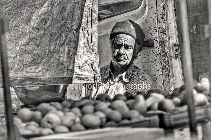 RealWorldImage's tweet image. A fruit vendor takes a moment to bask in the sunlight at a Park Whitechapel market in East London, England. Gary Moore photo. Real World Photographs. #streetphotography #London #England #Grok #Nikon #photography #Malmo #Copenhagen #Europe #photojournalism 
 #Nikon #LDN #UK