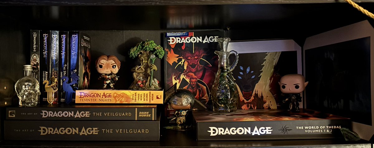 _meyward's tweet image. wanted to show off my dragon age collection so far (waiting on the inquisition artbook and to find emmrichs funko) #dragonage #decor