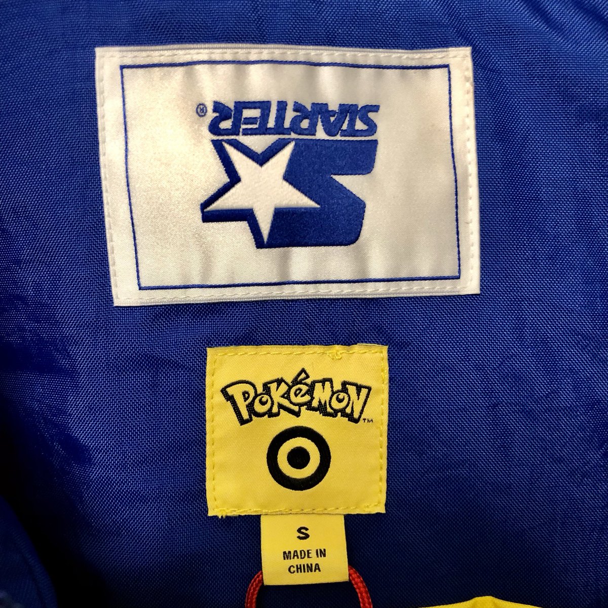 Gendron07's tweet photo. @PokemonDealsTCG I wish they had more of the inverted label starter jackets https://t.co/2Wpjr53zCJ