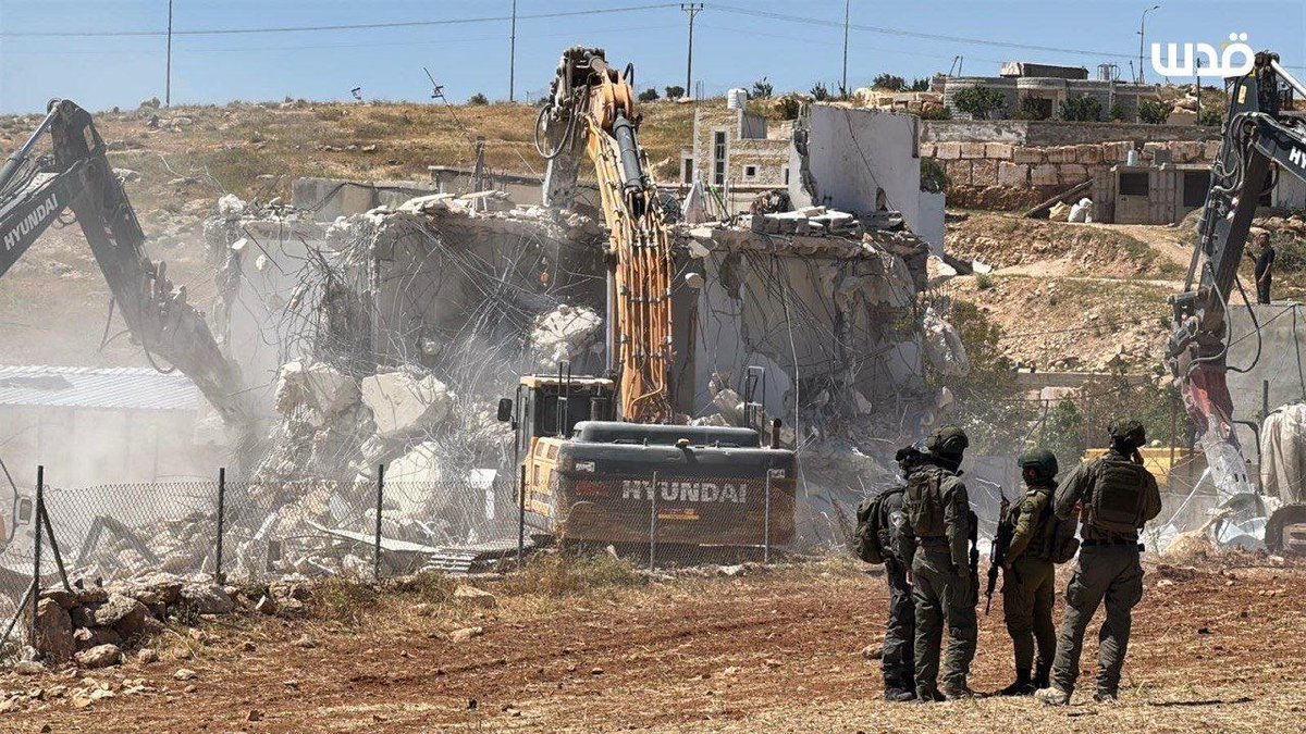 QudsNen's tweet image. Palestinians watch in grief as Israeli bulldozers demolish their home in the village of Ad-Deirat, south of Hebron, in the occupied West Bank.