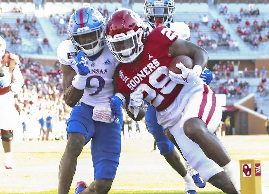 HurwitzSports's tweet photo. From Nov. 7, 2020: Oklahoma RB Rhamondre Stevenson runs for a touchdown against Kansas CB Karon Prunty.

Now both of them are teammates in New England. Stevenson is entering his sixth season, and Prunty is entering his first. https://t.co/0Rmv2xBWTr