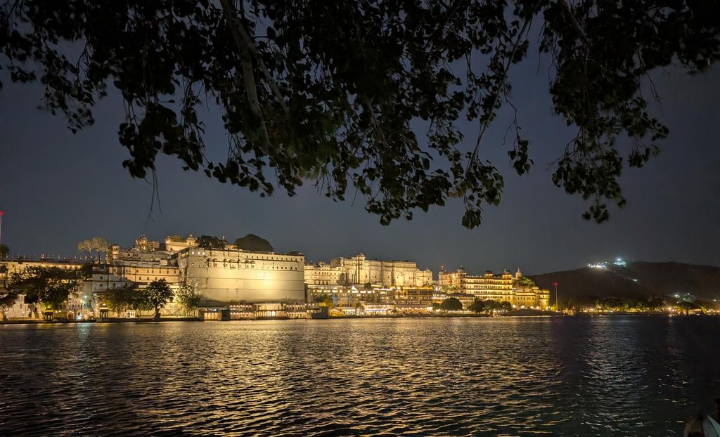 0xlelouch_'s tweet photo. The latest workation hack is here.

I have been working from udaipur for a week now.

So workation sounds fancy until you actually do it right.

It is not about waking up at 11, opening laptop in a cafe, pretending to work, then feeling guilty the whole day. Been there, did that, ngmi.

Real workation is simple:

- Wake up early.
- Finish the important work before the world becomes noisy.
- Use Claude, ChatGPT, Cursor or whatever tools you have to move faster, not to become lazy.
- Do the calls.
- Ship the tasks.
- Reply to people.
- Close the loops.

Then in the evening, go sit near a ghat for sometime and let your brain breathe.

Today I came to Ambrai Ghat and spending some time here after work. It feels so good and peaceful tbh.

And honestly, this is the kind of life software engineers should aim for.

Not just remote work where you are stuck in your room with Slack open all day.

But real location freedom.

Do focused work in the morning.
Explore a little in the evening.
Walk near water.
Sit silently.
Think about life.

Come back with a slightly clearer mind.

AI tools have made this much easier now. Earlier, you needed a perfect setup, multiple monitors, too much context switching. Now with Claude and ChatGPT, you can unblock yourself faster, write better, debug faster, understand code faster, and use your mental energy for the actual hard decisions.

But the trick is discipline.

AI will not save you if your daily pattern is broken.

You still need to wake up early.
You still need to focus.
You still need to finish the work first.

Then the travel feels earned.

Otherwise workation becomes just guilt in a different city.

Maybe this is the new dream for software engineers.

Not escaping work.

But designing a life where work, travel, health, learning, and peace can exist together.

Morning for deep work.
Evening for ghats.
Night for reflection.
Repeat.

Taking off my airpods now... What a relief .. ngl

I used to hate being a software engineer but some super smart guys came up with ai agents. It's the best job in the world rn.
