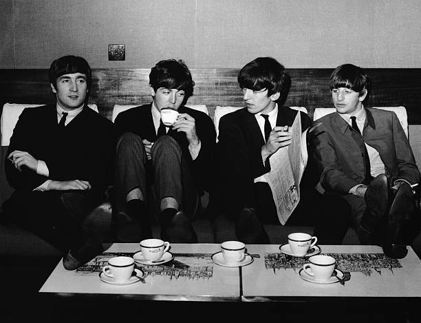 The Beatles taking a tea break, 1963. Photo from Getty Images.