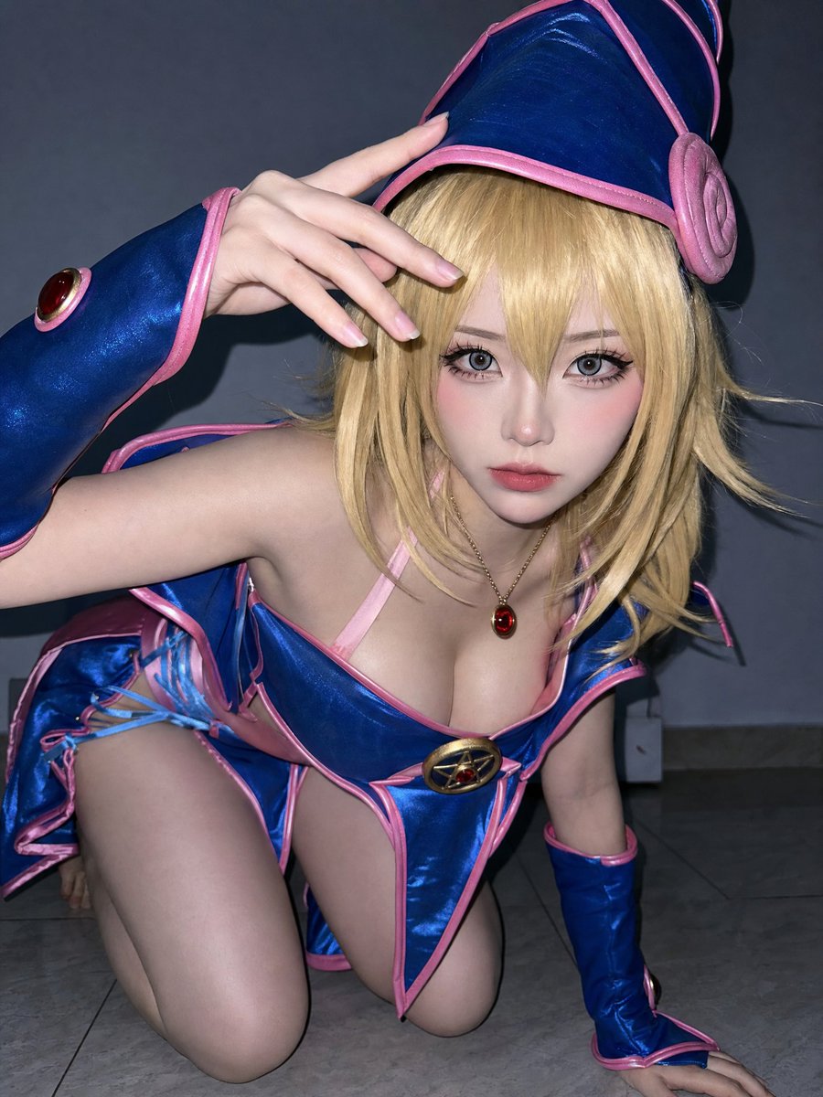 underwoodxie96's tweet photo. GPT image 2.0
prompt：
https://t.co/JxDFhmCify
{   "subject": {     "description": "a young woman in anime-style cosplay, crouching low and leaning toward the camera, with one hand raised near her forehead in a framing gesture, emphasizing large eyes and stylized facial proportions",     "mirror_rules": "not a mirror selfie, direct camera engagement, likely tripod or handheld close shot",     "age": "early 20s",     "expression": {       "eyes": {         "look": "wide open, highly focused",         "energy": "intense, slightly doll-like, alert",         "direction": "directly at camera"       },       "mouth": {         "position": "closed, softly relaxed",         "energy": "neutral, slightly cute stylization"       },       "overall": "anime-inspired expression, controlled, slightly seductive but stylized"     },     "face": {       "preserve_original": false,       "makeup": "heavy cosplay makeup, enlarged eye effect with circle lenses, soft gradient blush across cheeks and nose, smooth matte base, slightly overdrawn lips, strong eye definition"     }   },   "hair": {     "color": "bright blonde",     "style": "shoulder-length layered wig with bangs",     "effect": "synthetic wig texture, slightly fluffy with defined strands, mild shine from flash"   },   "body": {     "frame": "slim but with emphasized chest due to costume structure",     "waist": "narrow, partially exposed",     "chest": "pushed up and centered by costume, visually prominent",     "legs": "partially visible, crouched position",     "skin": {       "visible_areas": "shoulders, chest, cleavage, abdomen sides, upper thighs",       "tone": "very fair, slightly desaturated",       "texture": "artificially smooth, almost plastic-like due to strong flash and post-processing",       "lighting_effect": "hard frontal flash creates sharp specular highlights on skin, reflective shine on chest, shoulders and thighs"     }   },   "pose": {     "position": "low crouch on the floor",     "base": "one hand supporting body, the other raised near forehead",     "overall": "dynamic, slightly exaggerated pose to match anime character energy"   },   "clothing": {     "top": {       "type": "fantasy anime-style costume top",       "color": "blue with pink trim",       "details": "deep neckline exposing cleavage, structured bust design, central decorative emblem",       "effect": "tight and glossy material enhancing curves, slight reflective sheen"     },     "bottom": {       "type": "matching fantasy costume bottom",       "color": "blue and pink",       "details": "side cut-outs with crisscross lacing, short skirt or layered fabric",       "effect": "revealing design emphasizing hips and thighs"     }   },   "accessories": {     "headwear": "matching blue hat with pink trim",     "jewelry": "red gemstone pendant necklace",     "prop": "none clearly handheld"   },   "photography": {     "camera_style": "flash-heavy cosplay portrait, likely smartphone or compact camera",     "angle": "slightly above eye level but very close distance, wide-angle distortion",     "shot_type": "tight medium shot",     "aspect_ratio": "1:1",     "texture": "visible sharpening and smoothing, high contrast, slight digital noise",     "lighting": "direct on-camera flash, strong frontal lighting with minimal shadow diffusion",     "depth_of_field": "deep focus due to flash, background less blurred"   },   "background": {     "setting": "indoor room with minimal decoration",     "wall_color": "neutral gray-blue gradient",     "elements": ["plain wall", "floor surface"],     "atmosphere": "simple, studio-like but improvised",     "lighting": "dominated by flash, background slightly tinted by ambient light"   },   "the_vibe": {     "energy": "high visual impact, stylized",     "mood": "playful, cosplay performance, slightly provocative",     "aesthetic": "anime realism hybrid, artificial and polished",     "authenticity": "low realism, high stylization",     "intimacy": "direct and confrontational gaze",     "story": "she leaned forward mid-pose as if captured during a cosplay shoot moment",     "caption_energy": "caught mid spell"   },   "constraints": {     "must_keep": [       "anime cosplay styling",       "direct flash lighting",       "wide eyes with contact lens effect",       "blue and pink costume",       "crouching dynamic pose"     ],     "avoid": [       "natural lighting",       "realistic everyday styling",       "soft candid photography",       "dark moody tones",       "understated makeup"     ]   },   "negative_prompt": [     "natural skin",     "low contrast",     "no flash",     "realistic portrait",     "muted colors",     "soft lighting",     "plain clothing"   ] }