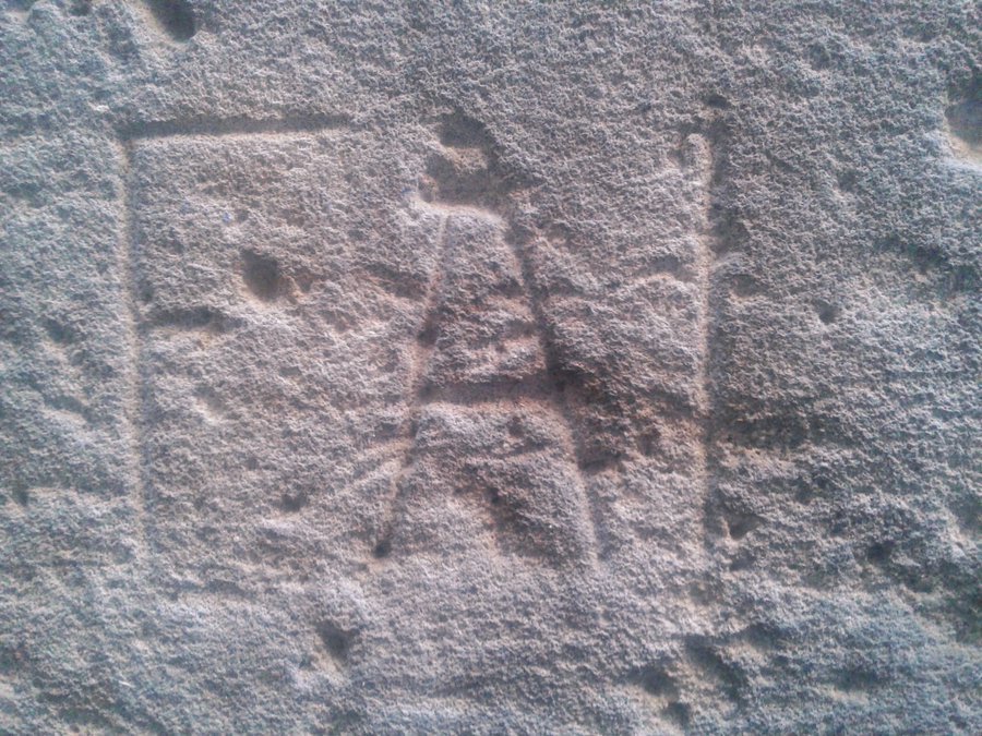 Letters of the FAI (Federación Anarquista Ibérica) chiseled into limestone wallin Barcelona's Gothic Quarter, near sea. Bullet marks superimposed prove from Civil War, possibly 1937 May Days, possibly small shrapnel. Not currently protected so decided not to give out a location