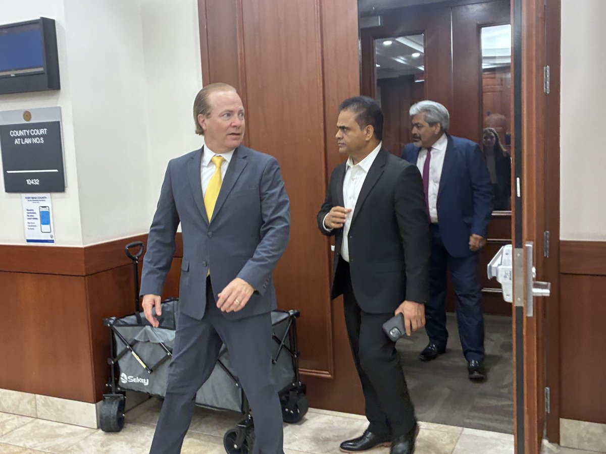 FortBendReport's tweet photo. Suspended Fort Bend County Judge KP George and attorneys Jared Woodfill and David Medina leave County Court-at-Law No. 5 Tuesday after prosecutors asked to "roll" his misdemeanor case until after the June sentencing in his felony case. Judge Teena Watson set trial for July 21. https://t.co/IH73uMyicI