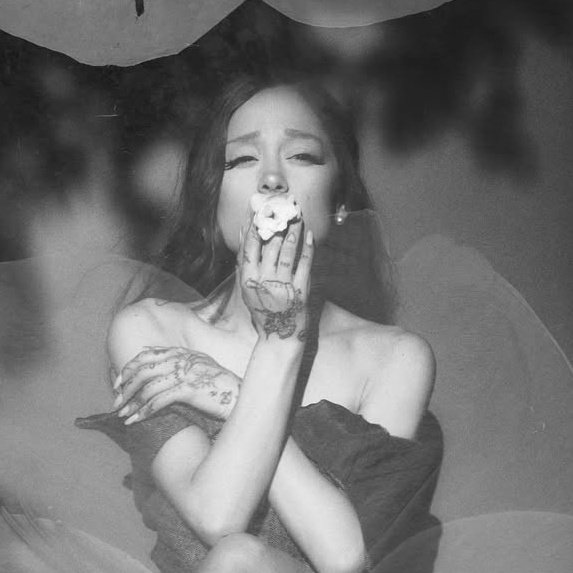 SHE'S SMOKING A FLOWER ???? 
oh bluntiana