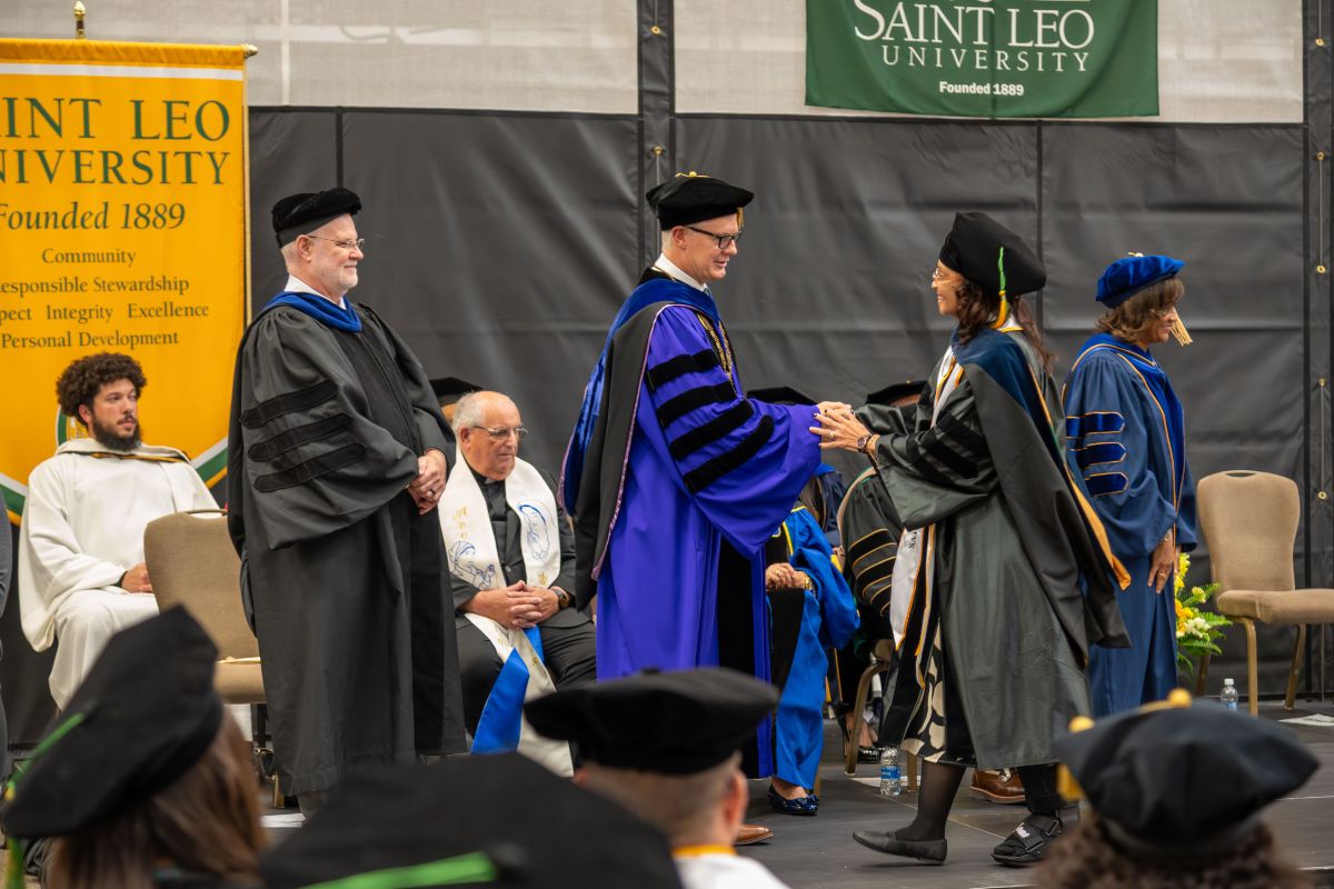 SaintLeoUniv's tweet photo. At today’s Doctoral Hooding Ceremony, graduates were formally recognized in the colors of their doctoral programs, marking the culmination of years of advanced study, research, and dedication. Congratulations to our newest Saint Leo doctors on this outstanding accomplishment. https://t.co/seQUCVg7eF