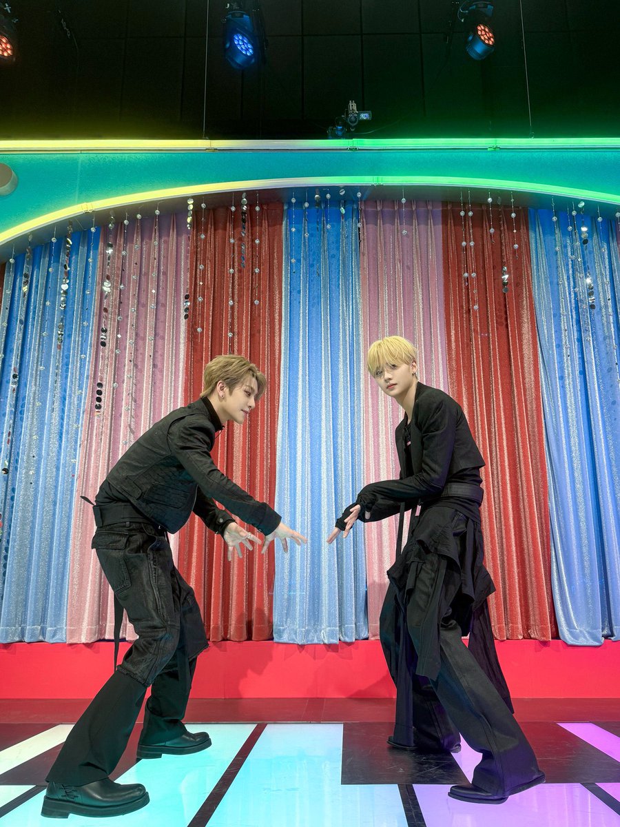 sannggwon's tweet photo. I felt like such a total main character taking this pic with Xinlong in our matching all black fits. Honestly, that red and blue glittery curtain backdrop is doing the absolute most and makes the whole thing look so much more alive. https://t.co/0FnqdQTqsQ