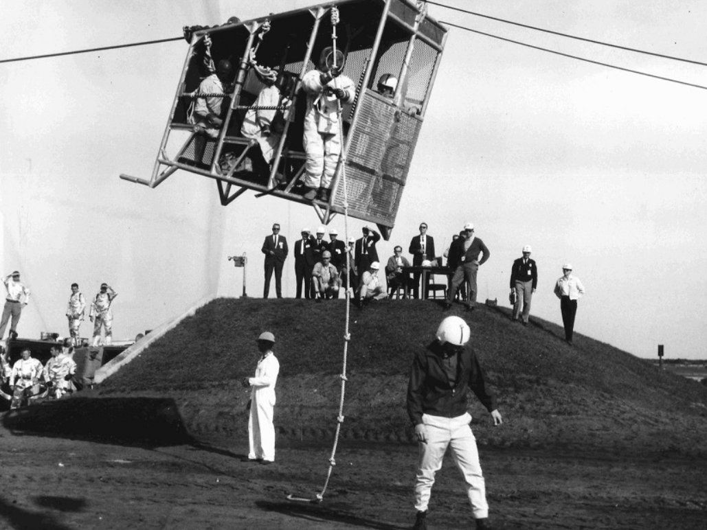 awe_130's tweet photo. CAPE KENNEDY, FLORIDA
SLIDE WIRE RUN—Astronaut Stuart A. Roosa, a member of the Apollo 9 support team, prepares to descend rope following the first manned run down a slide wire in a cab from the 320-ft. level of the mobile launch tower for Apollo 9 at Pad A, Launch Complex 39, Kennedy Space Center. Already down from the nine-man-capacity cab is Chuck Billings, KSC Safety Office. Awaiting his turn is Art Porcher, Design Engineering. The other six seats were occupied by weighted dummies.

An escape from a launch tower using a wire slide and a knotted rope? It really makes you think, especially since this was six months prior to the Apollo 11 launch!