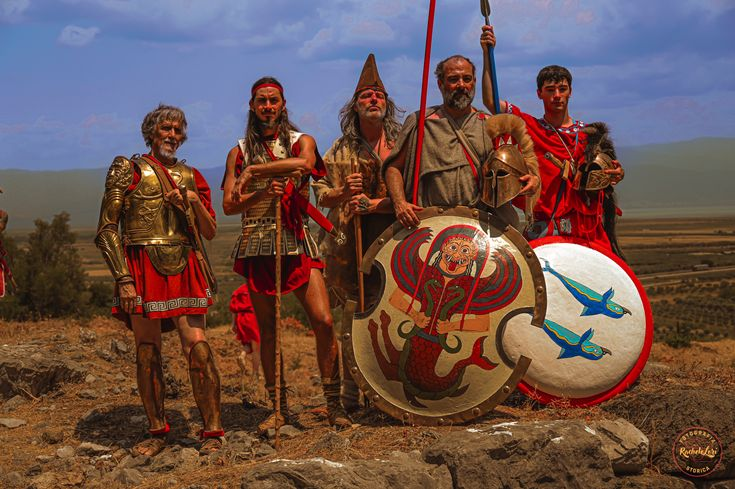 Knightly_Hist's tweet photo. I don't think it's invalid for them to be in full Armor.

It was a thing in the archaic period, you can argue it's a good choice to contrast with Odysses' crew more classical classical kit.

The issue is that Nolan's take looks fake and boring. https://t.co/qGepJbMBs2