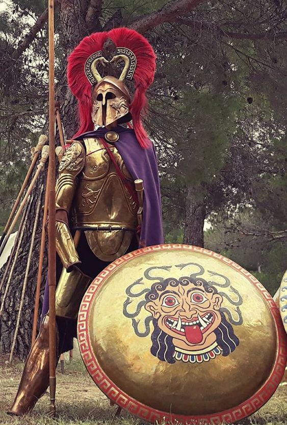 Knightly_Hist's tweet photo. I don't think it's invalid for them to be in full Armor.

It was a thing in the archaic period, you can argue it's a good choice to contrast with Odysses' crew more classical classical kit.

The issue is that Nolan's take looks fake and boring. https://t.co/qGepJbMBs2