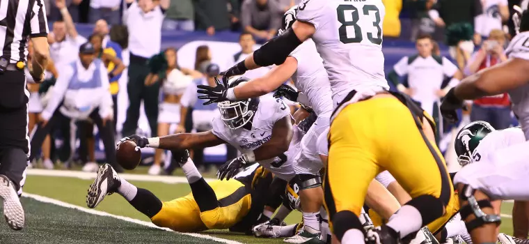 shammer64's tweet photo. @VinnysCorner1 Iowa vs MSU in the 2015 B1G Championship game. We had a view of that end zone from the nosebleeds. That arm just poked though when it looked like we stuffed them. I'm a Hawkeye, and my wife is a Spartan, so I had to act right even though I was torn up inside. https://t.co/jo14dVb0Qg