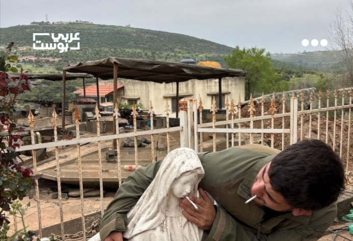 Liban : Un soldat israélien fumant une cigarette et en plaçant une autre dans une statue de la Vierge Marie
